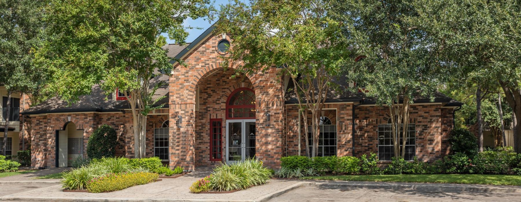 a brick building with trees around it